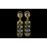 Tanzanite Pair of Drop Earrings, each earring comprising four oval cut tanzanites,