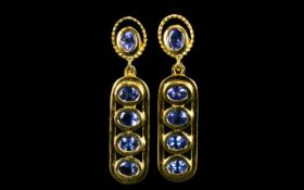 Tanzanite Pair of Drop Earrings, each earring comprising four oval cut tanzanites,