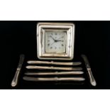 A Modern Silver Fronted Battery Operated Desk Clock Together with six silver handle butter knives