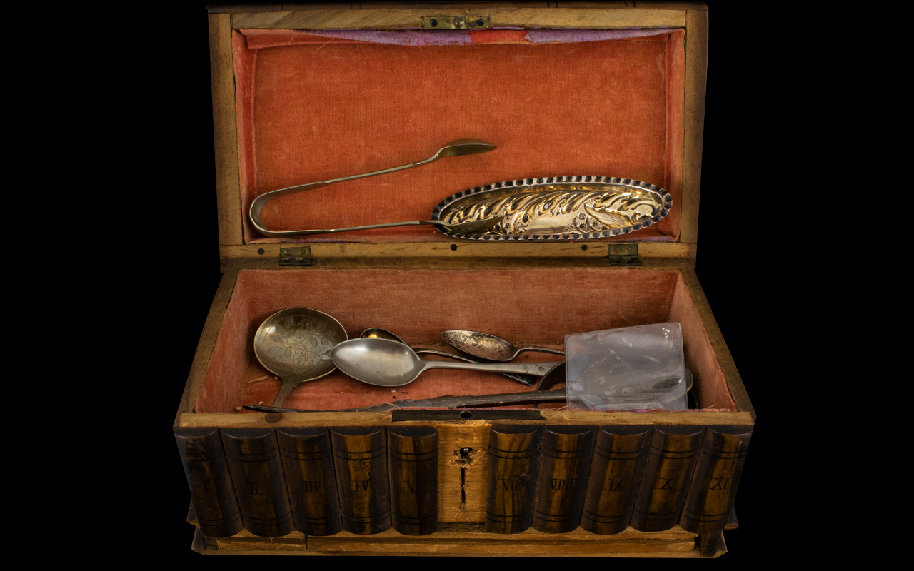 A Wooden Puzzle Box Containing a mixed lot of metalware to include white metal caddy spoon and