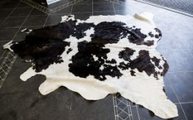 Large Cowhide Rug Of traditional form in chocolate brown and cream fur hide,