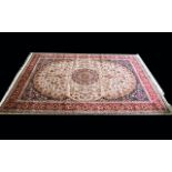 A Large Woven Silk Carpet Keshan rug with beige ground and traditional Middle Eastern floral and