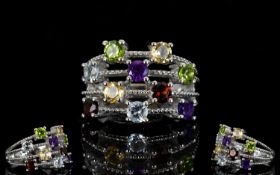 Multi Gem Four Row Scatter Ring, two round cuts of each, amethyst, red garnet, sky blue topaz,