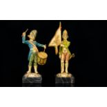 A Pair Of Novelty Resin Soldier Figures Each raised on Carrara marble bases, the first bearing a