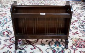 A Mahogany Magazine Rack Of typical form with lion head mask handles.