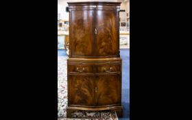 A Mid 20thC Mahogany Cocktail Cabinet marked to inner drawer 'Reprodux' comprising cabinet above