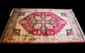 A Large Woven Silk Heriz Carpet Finley woven rug on red ground with intricate scrolling floral and