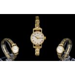Swiss Mondia Ladies Mechanical Wind 9ct Gold Bracelet Watch with attached 9ct gold bar bracelet and
