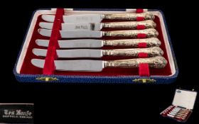 A Boxed Set of Elizabeth II Six Ornate Silver Handled Butter Knives all fully hallmarked and in