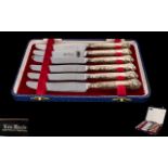 A Boxed Set of Elizabeth II Six Ornate Silver Handled Butter Knives all fully hallmarked and in