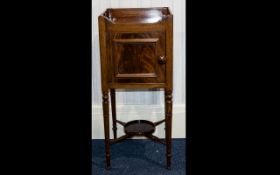 A Bedside Cabinet comprising gallery top above mahogany cupboard with cross stretcher,