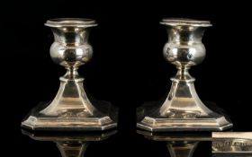 A Pair Of Squat Sterling Silver Candlesticks Of plain form raised on square bases, each fully