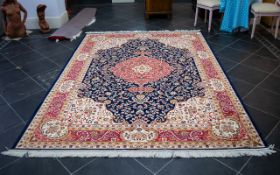 A Large Woven Silk Carpet Keshan rug with blue ground and traditional Middle Eastern floral and