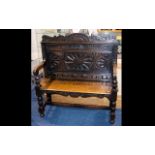 A Jacobean Style Oak Hall Bench - With carved backrest, turned supports, plank seat.