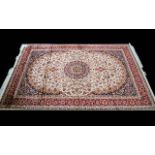 A Large Woven Silk Carpet Keshan rug with beige ground and traditional Middle Eastern floral and