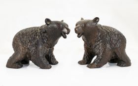 A Pair Of Black Forest Style Carved Bears Two black bears in prowling stance with glass eyes,