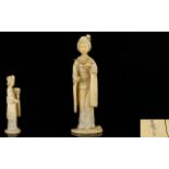 Japanese Meiji Period Well Carved Signed Ivory Figure of a standing Geisha girl holding a large