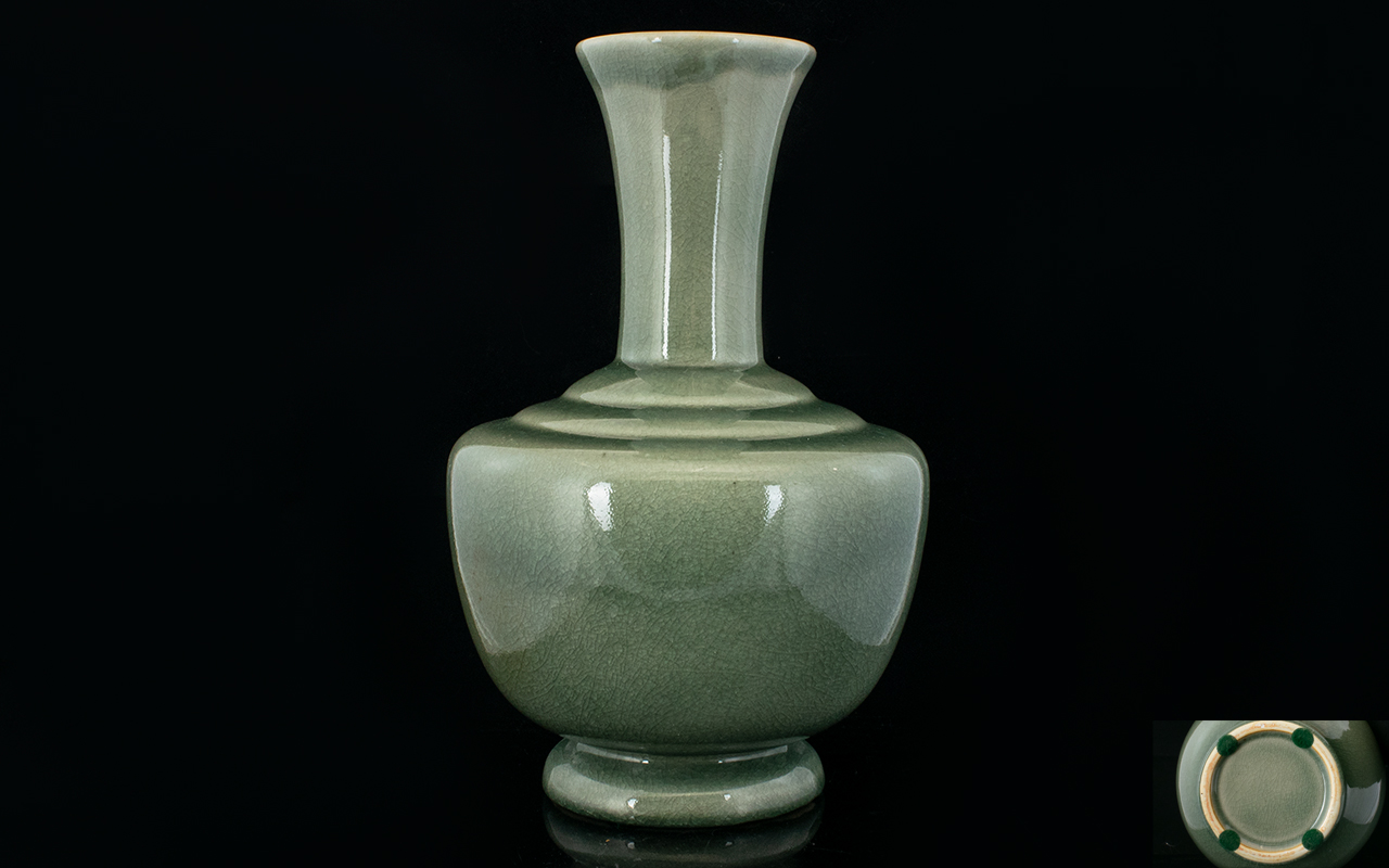Chinese Crackle Glaze Celadon Vase With Ovoid Body And Trumpet Neck.