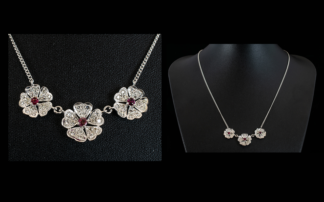 A Contemporary 18ct White Gold Ruby And Diamond Set Pendant Necklace Set with three flowerhead