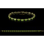 A 9ct Yellow Gold And Peridot Set Tennis Bracelet Fully hallmarked,