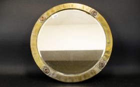 Arts And Crafts Style Bevelled Glass Mirror circular mirror in planished brass frame.