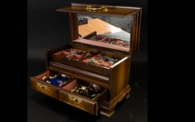 A Wooden Jewellery Box With hinged top and lift out tray with two drawers containing a small