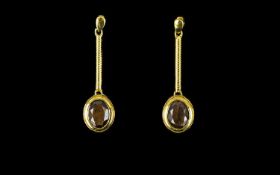 Golden Lustre Sapphire Drop Earrings, 5cts over two oval cut solitaires of the natural golden lustre