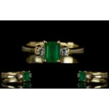 Ladies 18ct Gold Emerald and Diamond Dress Ring the central emerald of natural colour flanked by