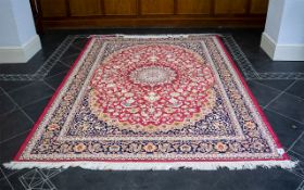 A Large Woven Silk Carpet Keshan rug with red ground and traditional Middle Eastern floral and