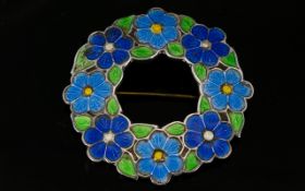 Enamelled Silver Floral Brooch Of circular form,