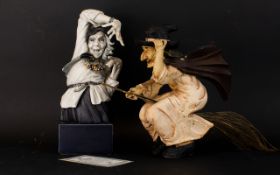 Two Figures In The Form of Witches The first in cast resin raised on square base,