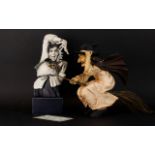 Two Figures In The Form of Witches The first in cast resin raised on square base,