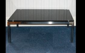 A Modern Glass Coffee Table Rectangular form in chromed metal and black glass, height 17 inches,