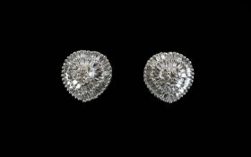 Pair of Diamond Cluster Earrings, a raised centre of round cut diamonds, closely framed with two