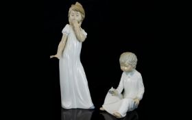 Nao by Lladro Pair of Porcelain Figures - Depict Young Boy and Girl In Nightdresses, The Boy with