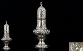 George III Handsome and Ornate Embossed Silver Pepperette of great proportions. Vacant cartouche.