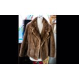 A Short Mink Evening Jacket Light golden brown hip length jacket with side seam pockets,