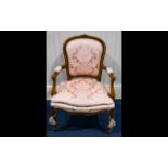 A Continental Armchair with carved supports, padded backrest and seat,