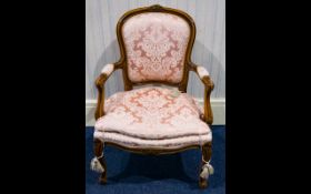 A Continental Armchair with carved supports, padded backrest and seat,