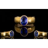 A 22ct Gold And Sapphire Ring Fully hallmarked for 22ct gold the centre set with oval faceted