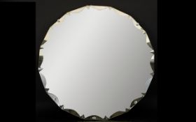 A Circular Bevelled Glass Mirror Large mirror with faceted semi-circular design to edge.