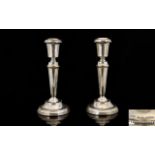 Elizabeth II Pair of Silver Candlesticks raised on a circular beaded stepped base.