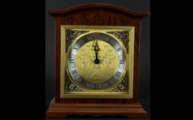 A Modern Reproduction Mantle Clock Wooden cased with etched and brushed gold tone face and silver
