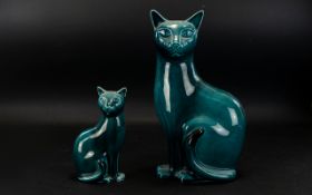 Poole Pottery A Pair Of Blue Glazed Cat Figures.