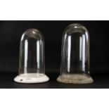 Two Glass Display Domes Each with circular ceramic base and domed glazed cloche. Tallest 15.