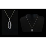 18ct White Gold Oval Shaped Diamond and Sapphire Pendant Drop on Attached 18ct White Gold Chain,