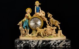 Novelty Figural Clock Raised on black marble base the brushed metal dial with Roman numerals,