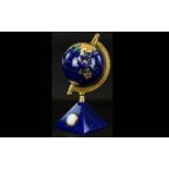 Small Decorative Globe and Clock. Attractive globe in deep blue and gold, on pyramid base containing