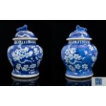 A Pair Of Chinese Ginger Jars And Covers Blue and white with prunus design throughout.