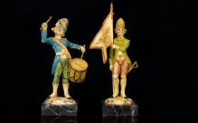 A Pair Of Novelty Resin Soldier Figures Each raised on Carrara marble bases, the first bearing a